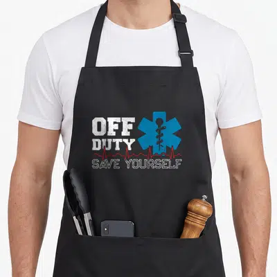 Tablier de cuisine noir avec inscription Off Duty Save Yourself et étoile bleue de la santé sur fond gris.
