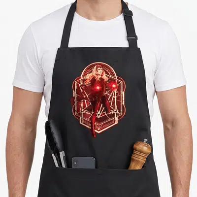 Tablier de cuisine noir avec illustration rouge et blanche de la Sorcière Rouge entourée de symboles magiques géométriques.