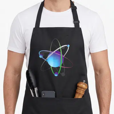 Tablier de cuisine noir avec illustration colorée d'un atome aux orbites multicolores et noyau bleu dégradé.
