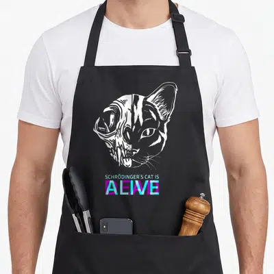 Tablier de cuisine noir avec illustration d'un demi-squelette et demi-chat blanc et texte Schrödinger's Cat is Alive en violet et cyan.