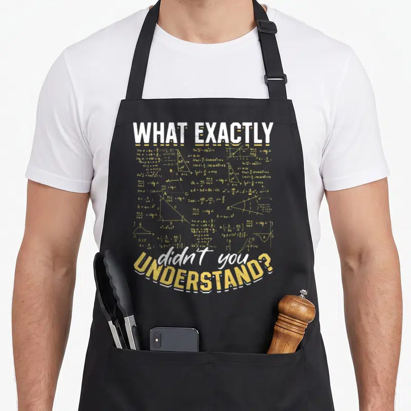 Tablier de cuisine noir avec l'inscription What exactly didn't you understand sur fond d'équations mathématiques jaunes.