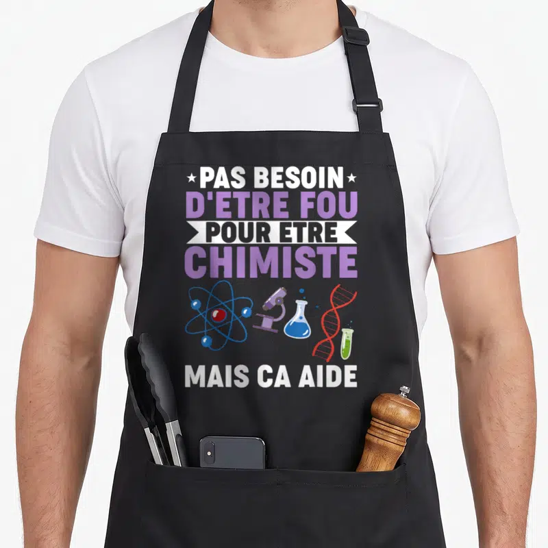 Tablier de cuisine noir avec inscription Pas besoin d'être fou pour être chimiste mais ça aide et illustrations scientifiques colorées.