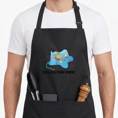 Tablier de cuisine noir avec illustration colorée d'une cellule eucaryote et le texte Cell Culture Inside en bas.