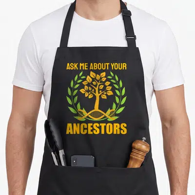 Tablier de cuisine noir avec un arbre doré, une double hélice d'ADN et des feuilles vertes entourées de texte orange.