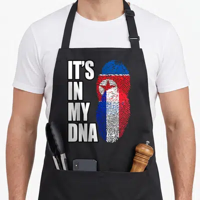 Tablier de cuisine noir avec texte It's in my DNA et empreinte digitale aux couleurs de la Corée du Nord et de la France.