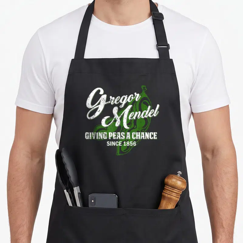 Tablier de cuisine noir avec illustration de pois verts et texte blanc Gregor Mendel Giving Peas a Chance Since 1856.