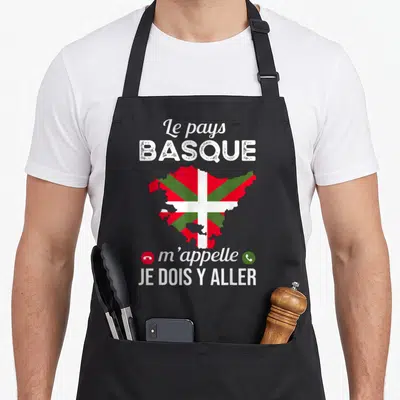 Tablier de cuisine noir avec une carte du Pays Basque en Ikurriña et le texte Le pays basque m'appelle je dois y aller.