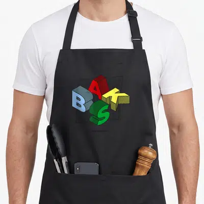 Tablier de cuisine noir avec le logo BAKS en lettres 3D multicolores et l'inscription Basque Wearhouse en bas.