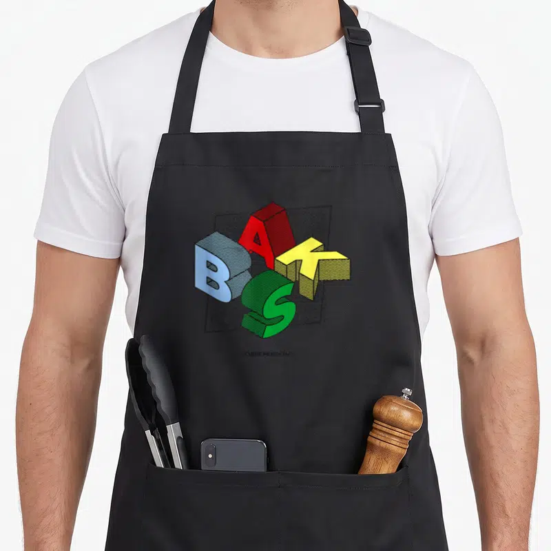 Tablier de cuisine noir avec le logo BAKS en lettres 3D multicolores et l'inscription Basque Wearhouse en bas.
