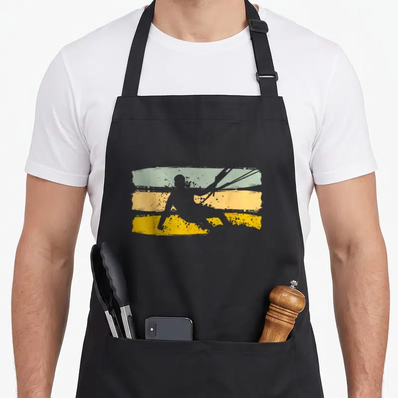 Tablier de cuisine noir avec silhouette kiten et bandes vertes jaunes vintage.