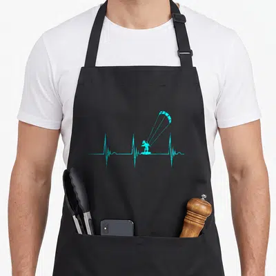 Tablier de cuisine noir avec un kitesurfer turquoise intégré dans une ligne de battement de cœur stylisée.