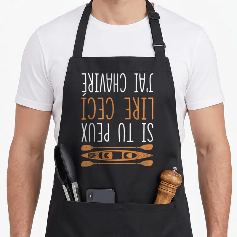 Tablier de cuisine noir avec texte blanc et orange Si tu peux lire ceci j'ai chaviré surmontant un kayak et des pagaies.