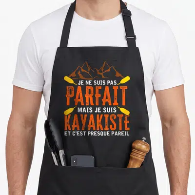 Tablier de cuisine noir avec inscription Je ne suis pas parfait mais je suis kayakiste et illustration de pagaies et montagnes.