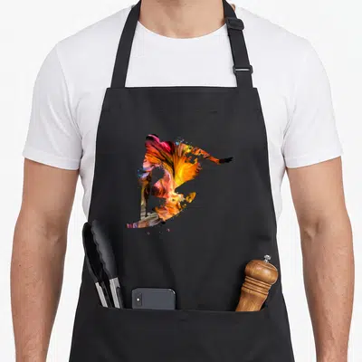 Tablier de cuisine noir avec une silhouette de surfeur abstraite aux couleurs vives orange, jaune et rose.
