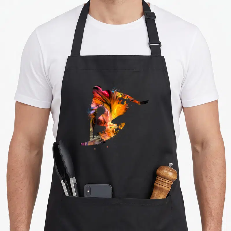 Tablier de cuisine noir avec une silhouette de surfeur abstraite aux couleurs vives orange, jaune et rose.