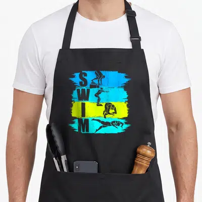 Tablier de cuisine noir avec illustration colorée SWIM et silhouettes de nageurs en action sur bandes bleues et jaunes.