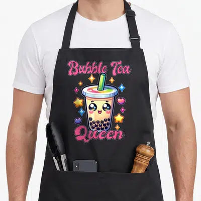 Tablier de cuisine noir avec un gobelet de thé aux perles mignon, des étoiles colorées et les mots Bubble Tea Queen en lettres roses.