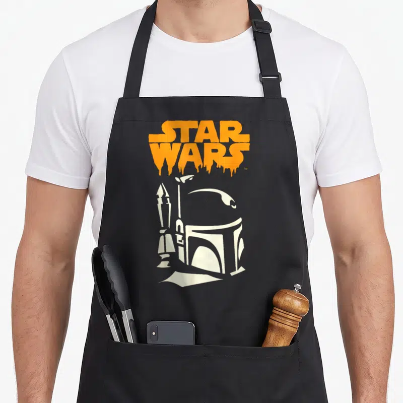 Tablier de cuisine noir avec logo Star Wars orange coulant et illustration blanche de Boba Fett tenant une arme.