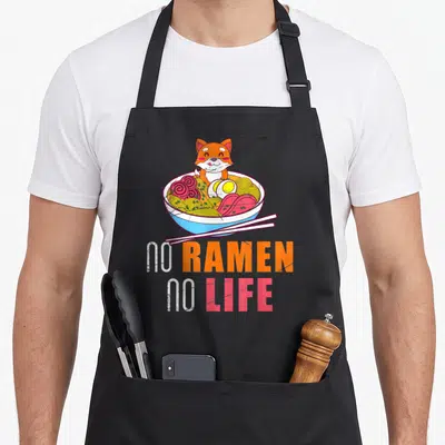 Tablier de cuisine noir avec illustration d'un Shiba Inu dans un bol de ramen et texte No Ramen No Life.