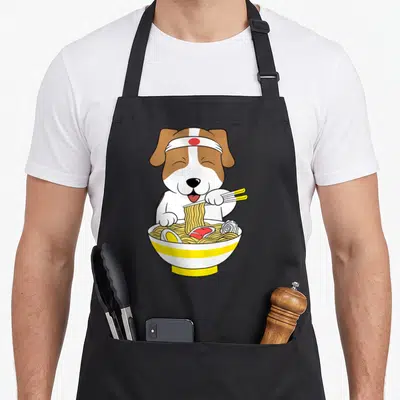 Tablier de cuisine noir avec un Jack Russell Terrier mangeant du ramen avec des baguettes jaunes.