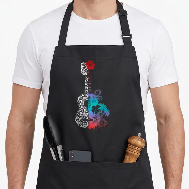 Tablier de cuisine noir avec ukulélé blanc tribal, fleur rouge et paysage tropical bleu violet