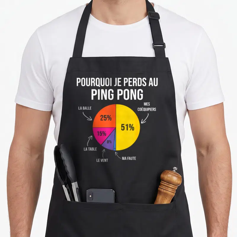Tablier de cuisine noir avec un diagramme circulaire coloré illustrant les raisons de la défaite au ping pong et l'optimisme démesuré du joueur.