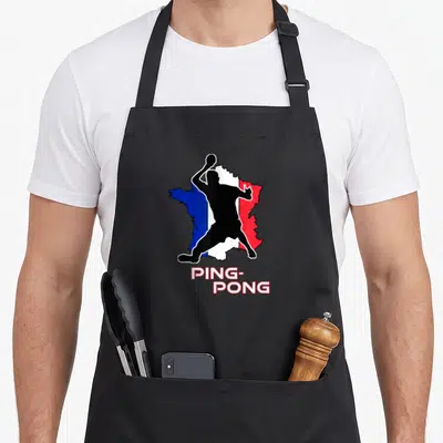Tablier de cuisine noir avec une carte de France et un joueur de ping-pong en silhouette noire au centre.