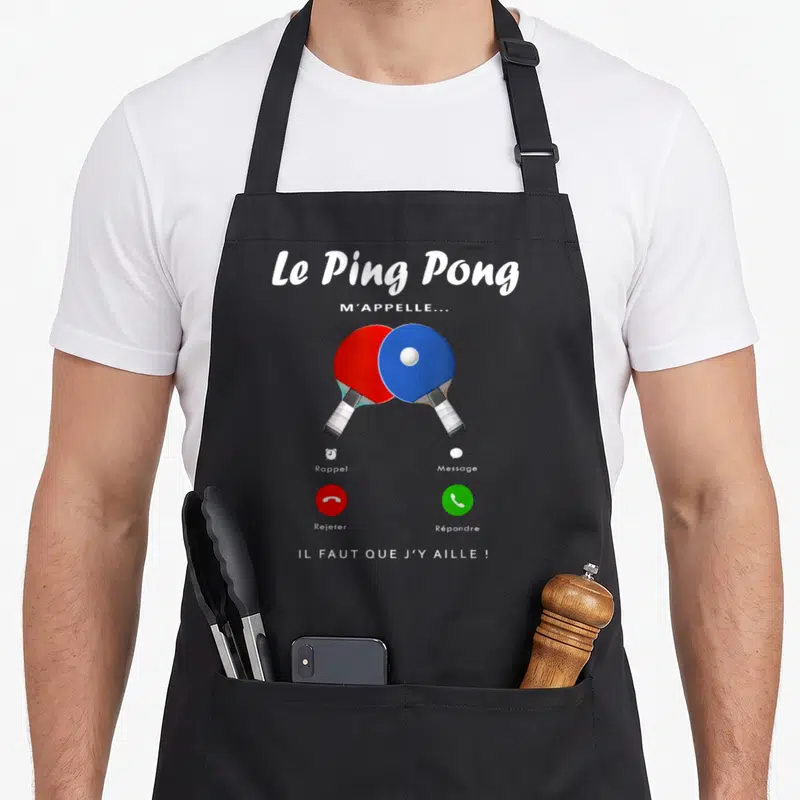 Tablier de cuisine noir avec deux raies de ping-pong rouge et bleue et texte blanc imitant une notification.