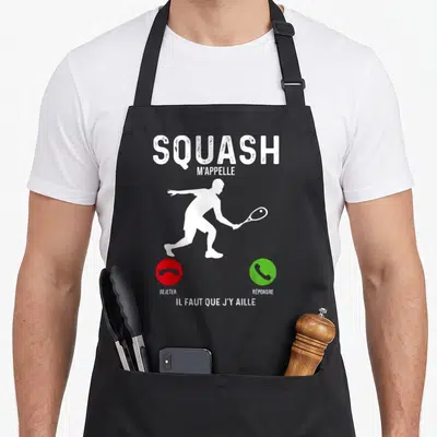Tablier de cuisine noir avec silhouette joueur squash et texte Squash m'appelle Il faut que j'y aille.