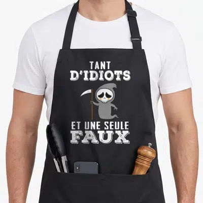 Tablier de cuisine noir avec une illustration de la Faucheuse La Mort tenant une faux et le texte Tant d'idiots et une seule faux.