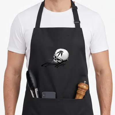 Tablier de cuisine noir avec un crâne blanc portant une feuille noire et le logo Cypress Hill en dessous.