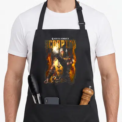Tablier de cuisine noir avec illustration du personnage Scorpion entouré de flammes et du logo Mortal Kombat X en haut.