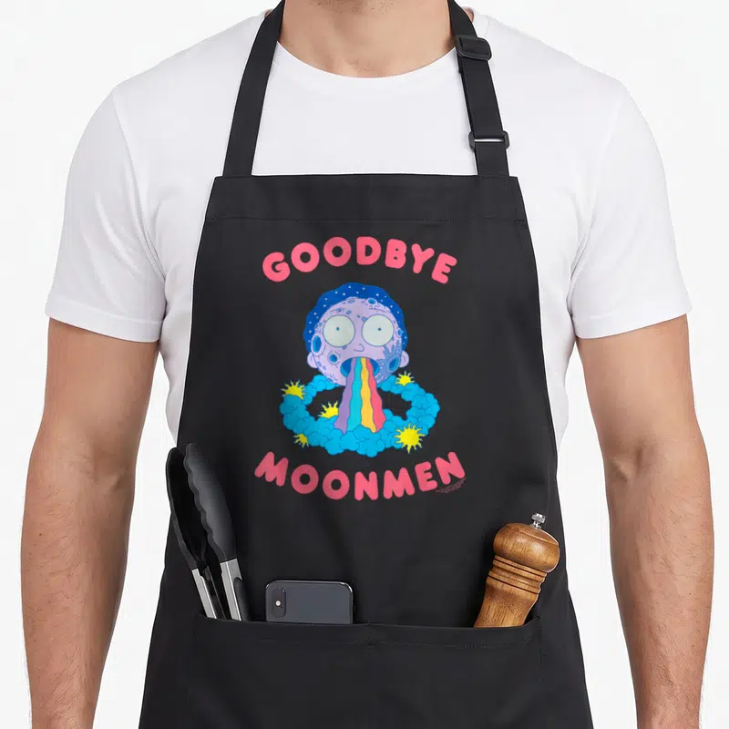 Tablier de cuisine noir avec illustration colorée de Rick vomissant un arc-en-ciel sous le texte Goodbye Moonmen en rose.