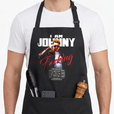 Tablier de cuisine noir avec illustration d'I Am Johnny Cage F*cking et logo Mortal Kombat en bas à droite.