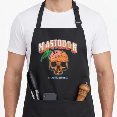 Tablier de cuisine noir avec illustration d'un crâne orange en forme de pêche et du texte Mastodon Atlanta Georgia en lettres rétro.
