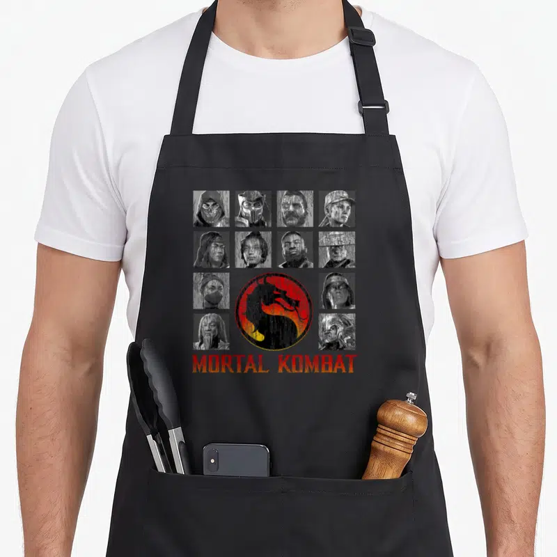 Tablier de cuisine noir avec une grille de portraits de personnages et un logo de dragon rouge au centre.
