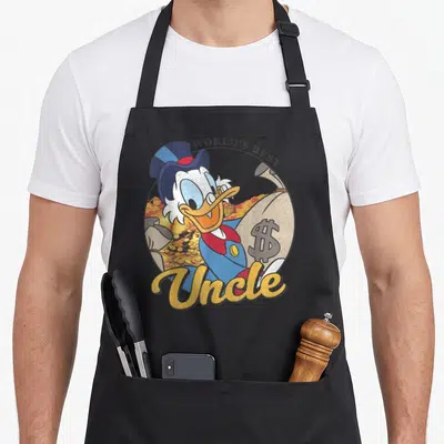 Tablier de cuisine noir avec Scrooge McDuck tenant un sac d'argent et l'inscription World's Best Uncle en lettres dorées.