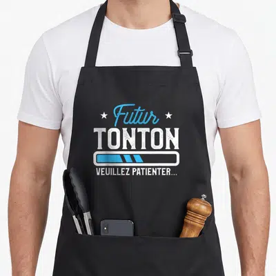 Tablier de cuisine noir avec inscription Futur Tonton et barre de chargement bleue.