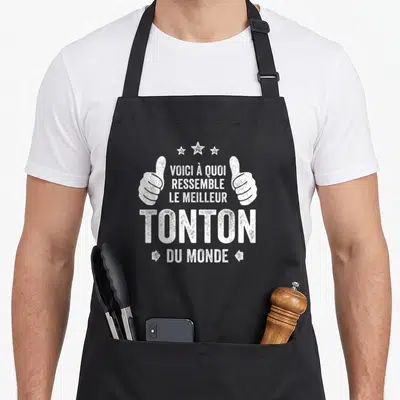 Tablier de cuisine noir avec inscription blanche Voici à quoi ressemble le meilleur tonton du monde et deux pouces levés.