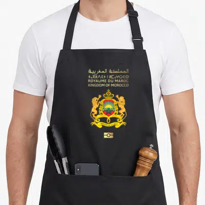Tablier de cuisine noir avec les armoiries du Royaume du Maroc, deux lions dorés et une couronne royale au centre.