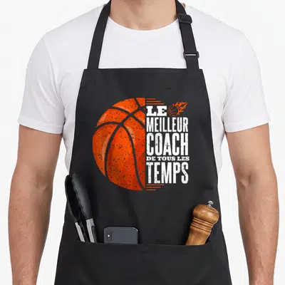 Tablier de cuisine noir avec illustration d'un ballon de basket orange et le texte Le Meilleur Coach de Tous les Temps en blanc.