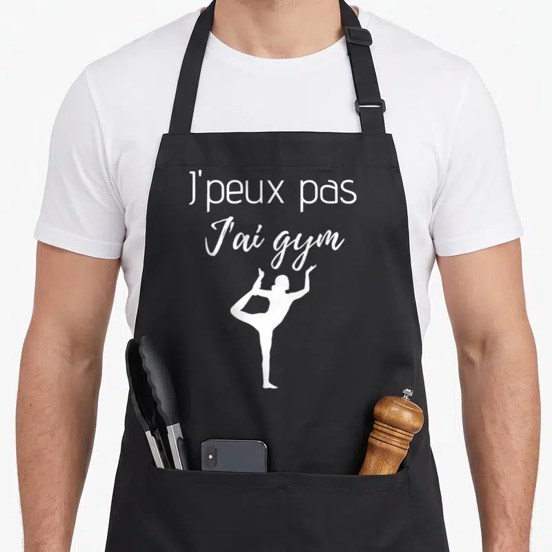 Tablier de cuisine noir avec inscription J'peux pas J'ai gym et silhouette de personne en posture de yoga blanche.