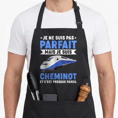 Tablier de cuisine noir avec illustration d'un train TGV bleu et blanc et texte humoristique sur la profession de cheminot.