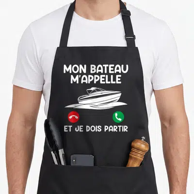 Tablier de cuisine noir avec illustration de yacht blanc et texte Mon Bateau M'Appelle, icônes téléphone rouge et vert.