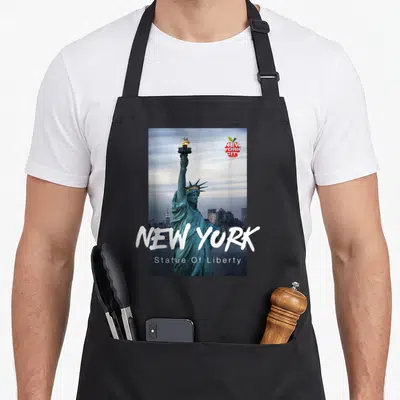Tablier de cuisine noir avec une illustration de la Statue of Liberty et le texte New York en lettres blanches.