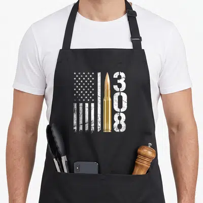 Tablier de cuisine noir avec une cartouche dorée, un drapeau américain blanc et le texte 308 en typographie usée.