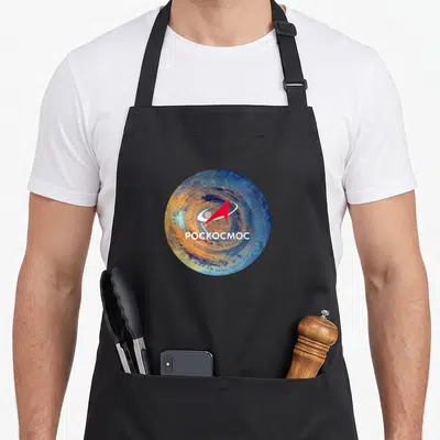 Tablier de cuisine noir avec un logo circulaire bleu et orange portant la flèche rouge et le texte ROSSICOCMOC en blanc.