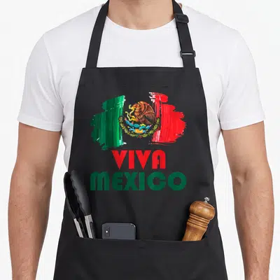 Tablier de cuisine noir avec illustration du drapeau Mexique et texte Viva Mexico en rouge et vert.