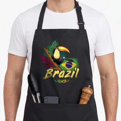 Tablier de cuisine noir avec illustration d'un toucan, drapeau du Brésil, texte Brazil et masque de carnaval en bas.