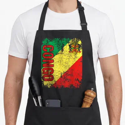 Tablier de cuisine noir avec drapeau Congo vert jaune rouge et inscription CONGO en lettres rouges verticales.